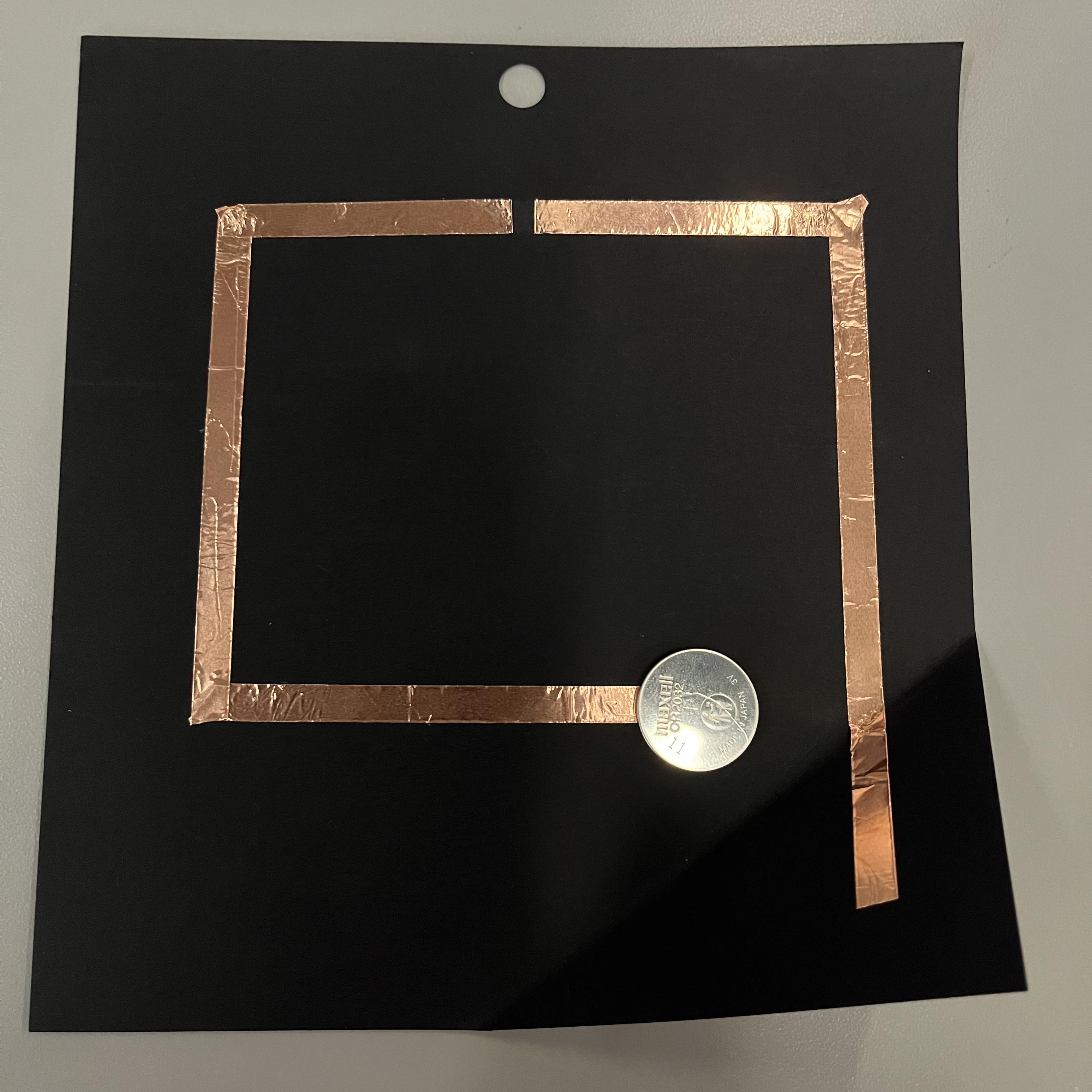 I used a box cutter knife to trim a piece of the copper tape to create a gap for the LED light to fit in. Now the circuit has a positive side and a negative side.